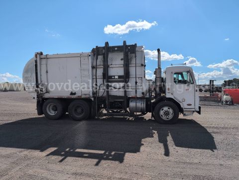 2002 Peterbilt 320 with Impac 32 yd commercial side load refuse body