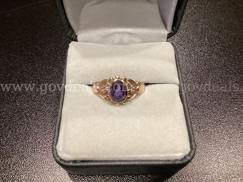 14k Gold Ring with a purple Stone