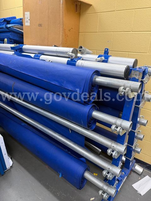 Gym floor covering rolls for 96' gym floor. Tool included to operate the rack.