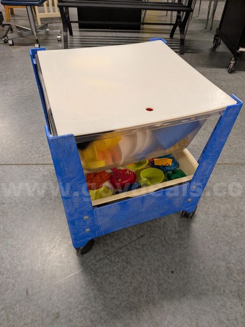 small sensory table with many toys/tools