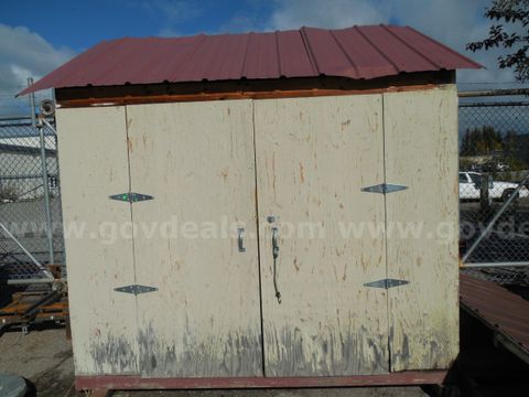 Wooden storage shed with additional roof segment
