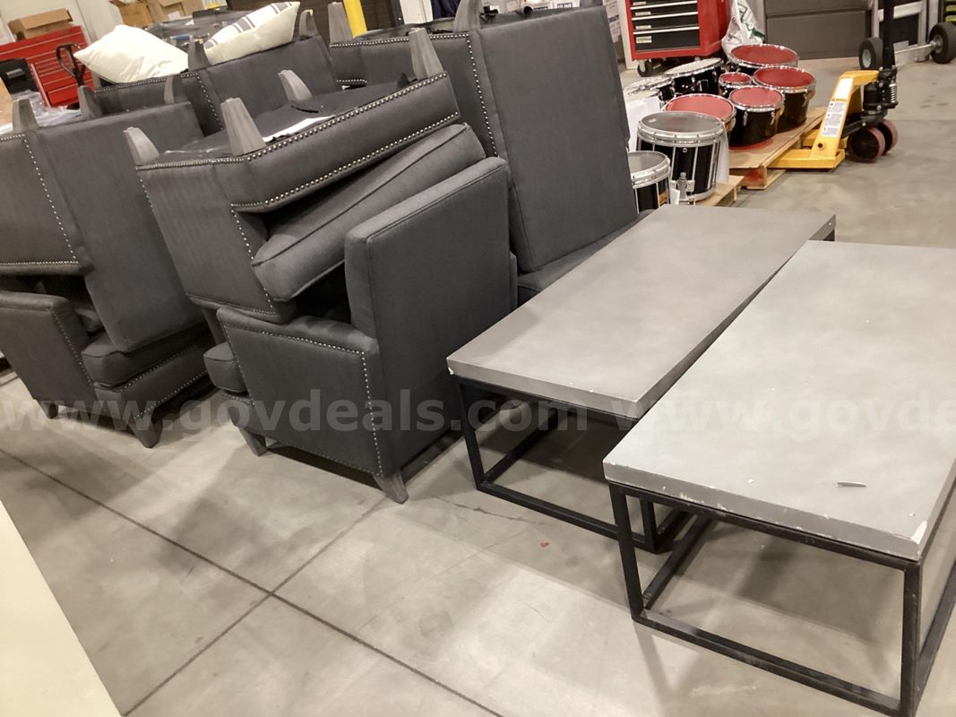8 large grey chairs and 2 tables