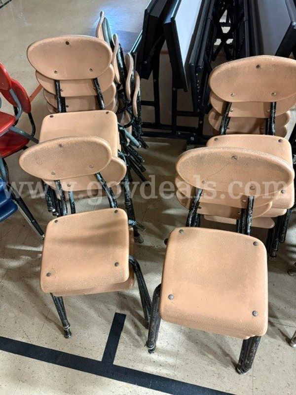 Stack of plastic chairs seen in photo