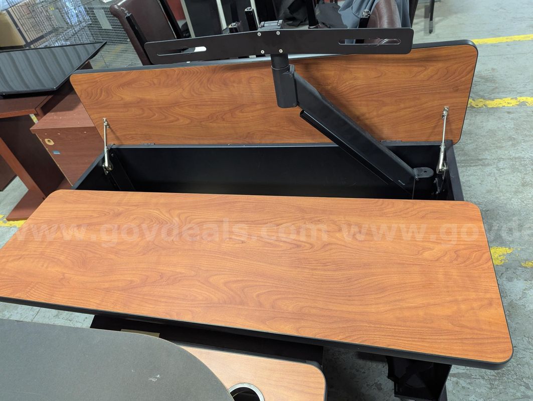 Used workstation desk with pop-up monitor arm, wood‑grain top and rolling base