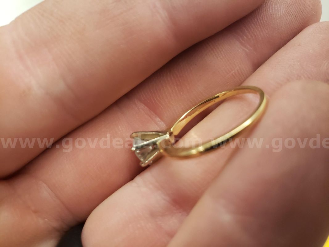 Gold colored ring with clear stone