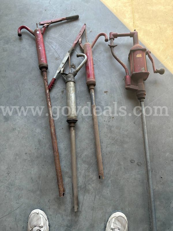 Several used hand pumps for fluid transfer