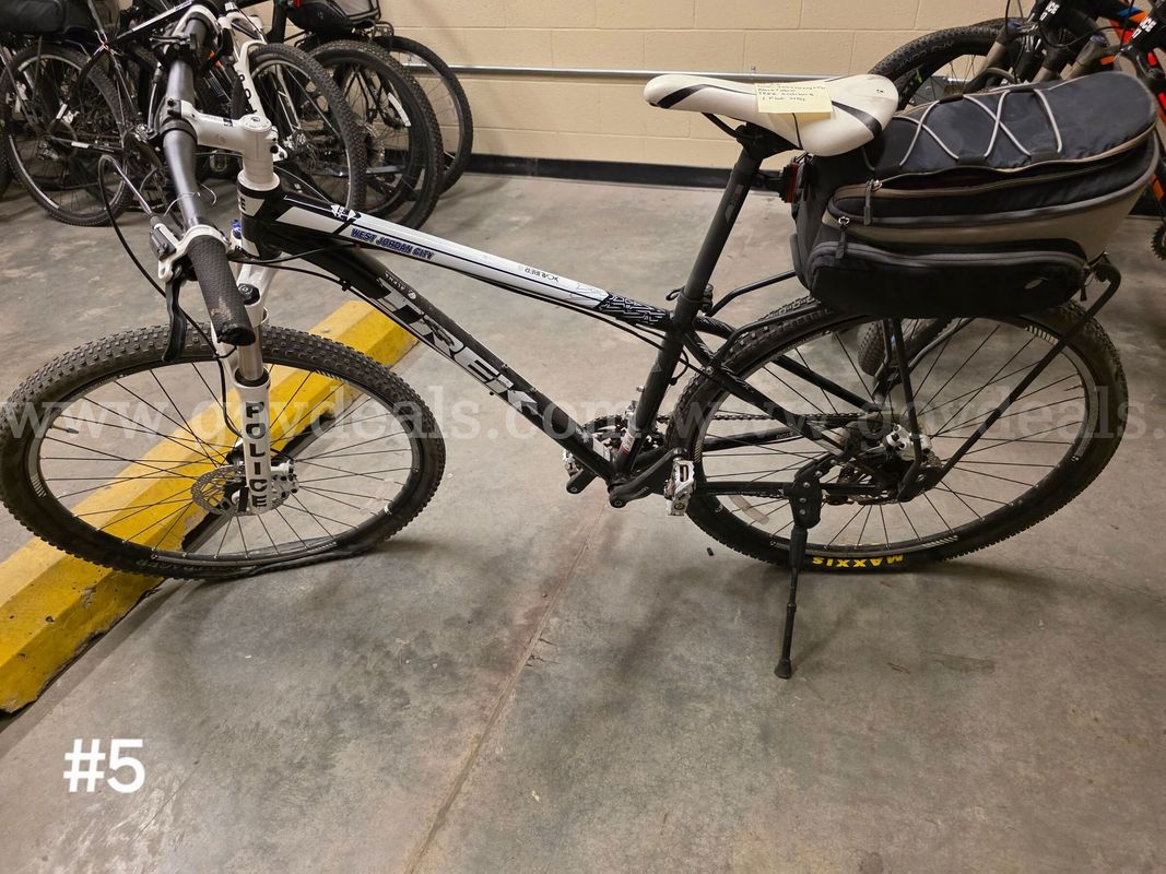 Used black and white Trek Xcaliber8 bike. Bike tires are flat.