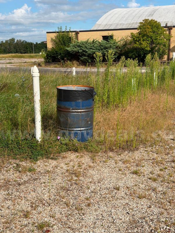 unknown amount - 50 gallon metal garbage barrel