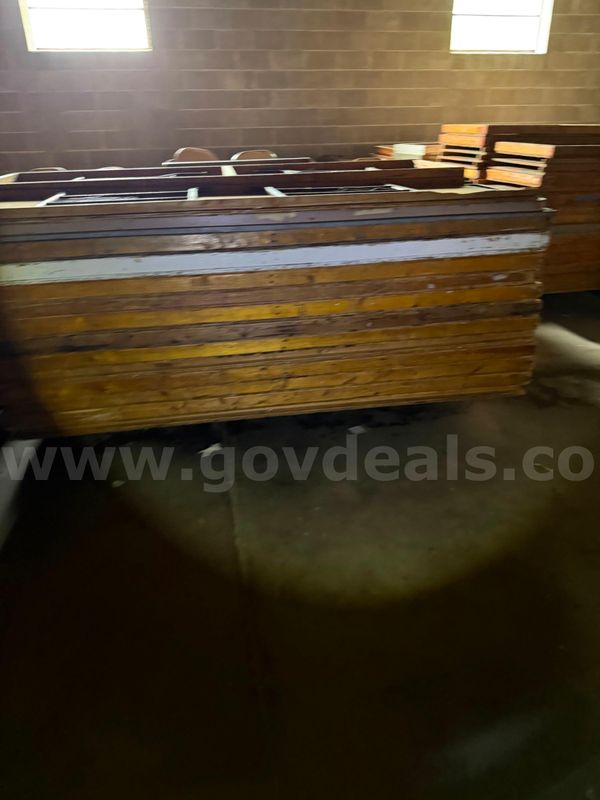 Lot of unknown amounts of foldable wooden tables with metal legs.