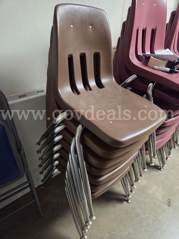 Lot of 7 stacking brown plastic chairs