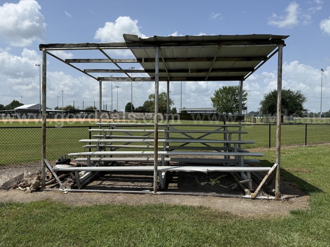 5 sets of bleachers on metal frames with skids