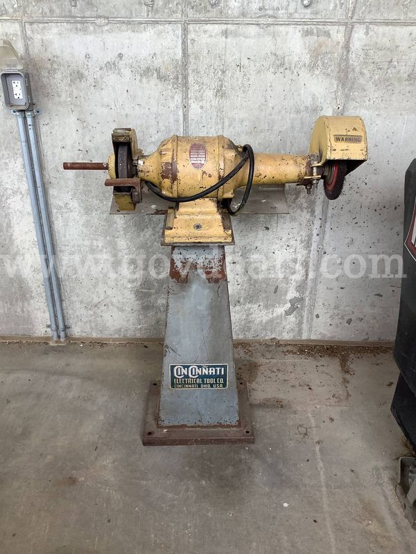 Bench grinder on pedestal.