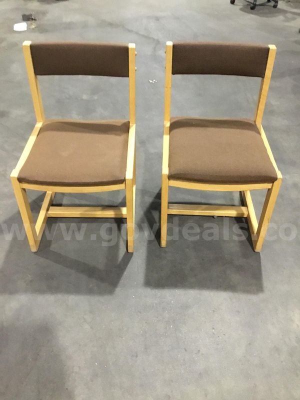 Two dark brown armless chairs; with side light oak wood frame "DH"