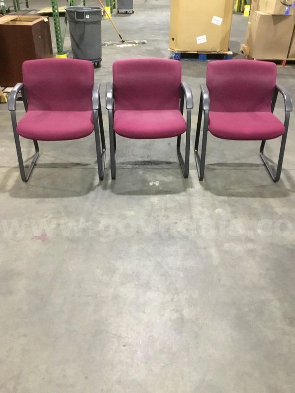 Three burgundy sled chairs; with black padded armrests "DH"