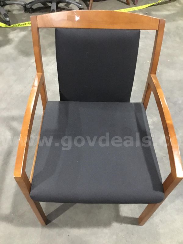 Black chair; with dark brown hardwood armrests “DH”