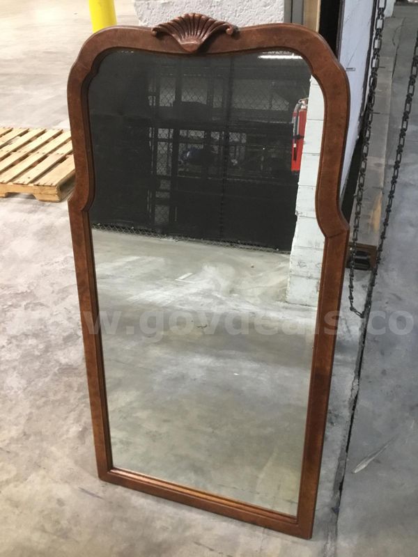 25 (LENGTH) x 48 (HEIGHT) glass mirror; with a dark brown wood exterior “DH”