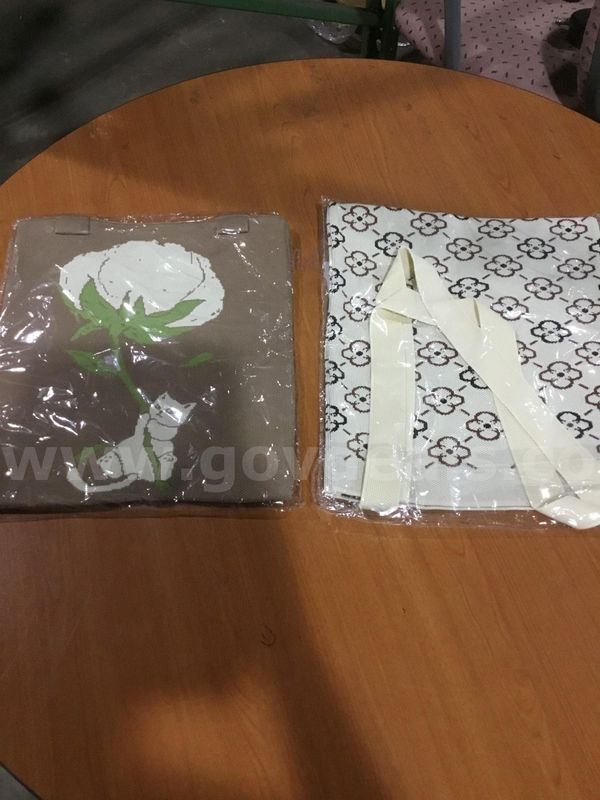 Brown bag, with a kitten grabbing a flower, and a tan flower bag "DH"