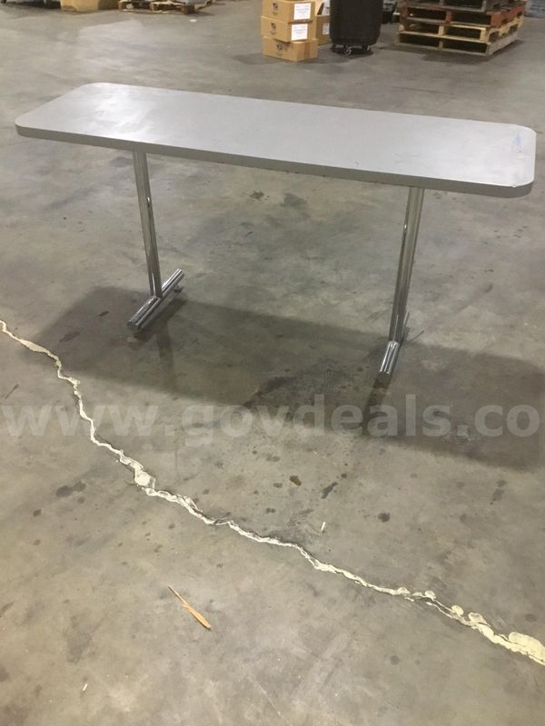 60 x 20 gray rectangular table, with two steel silver leg stands (TABLE IS SLIGHTLY WOBBLY) "DH"