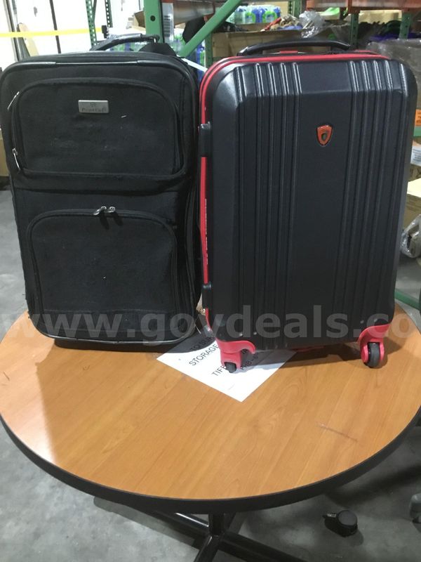 All black luggage bag, & a red & black luggage bag "DH"