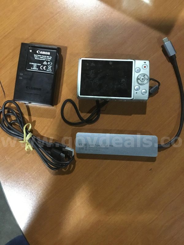 Lot of items-battery pack, usb hub cord, silver camera (IT TURNS ON) "DH"