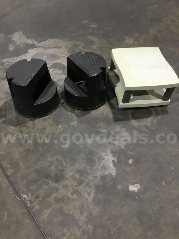 Two black step stools, white cart is missing one leg "DH"