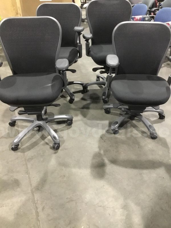4 black office chairs; with black padded armrests "DH"