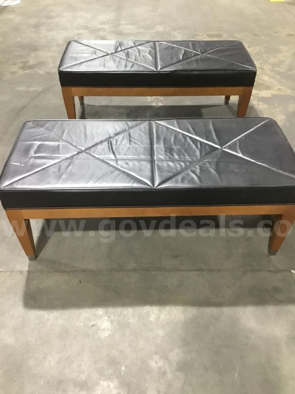 Two 48 1/2 x 28 1/2 black leather bench seats; four brown wood leg stands "DH"