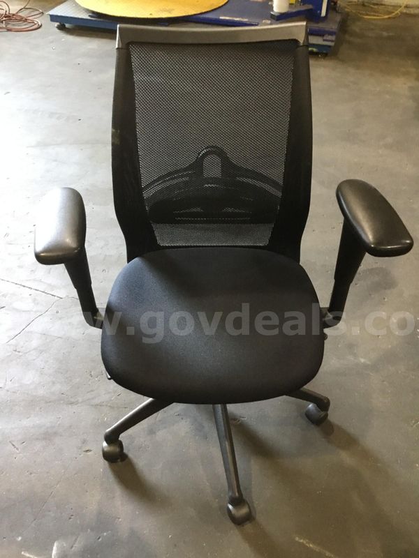 Black office chair; with black padded armrests "DH"
