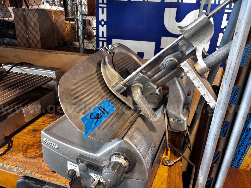 Used commercial kitchen equipment lot with 2 slicers, 1 press, and 1 hot dog electric grill roller