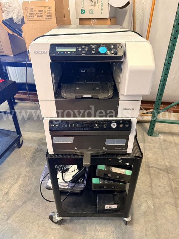 Ricoh Ri 100 Direct to Garment Printer with Ricoh Rh 100 finishing unit.