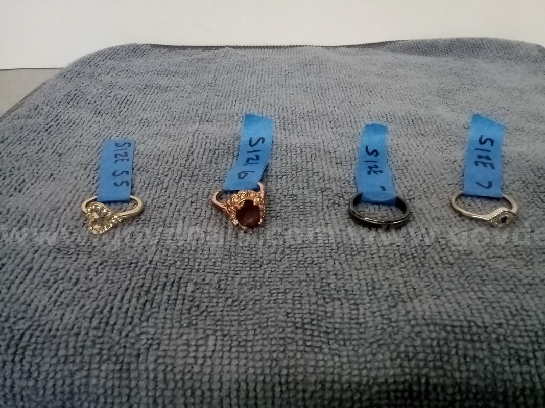 4 Rings - 1 Copper/Brass-toned ring, 1 Black ring, 1 Gold-toned ring, 1 Silver-toned ring