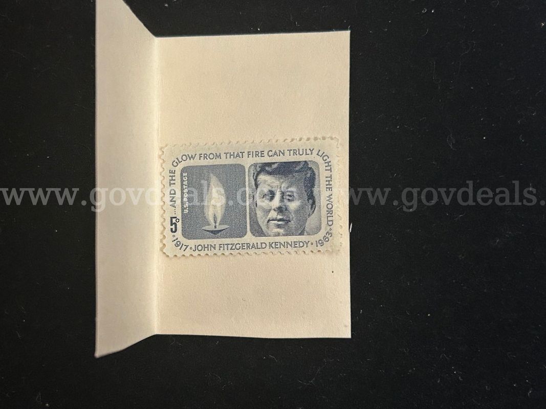 JOHN FITZGERALD KENNEDY 1917-1963 5 CENT STAMP & SIX MISC TOKENS/BUS PASS/SCRIPT