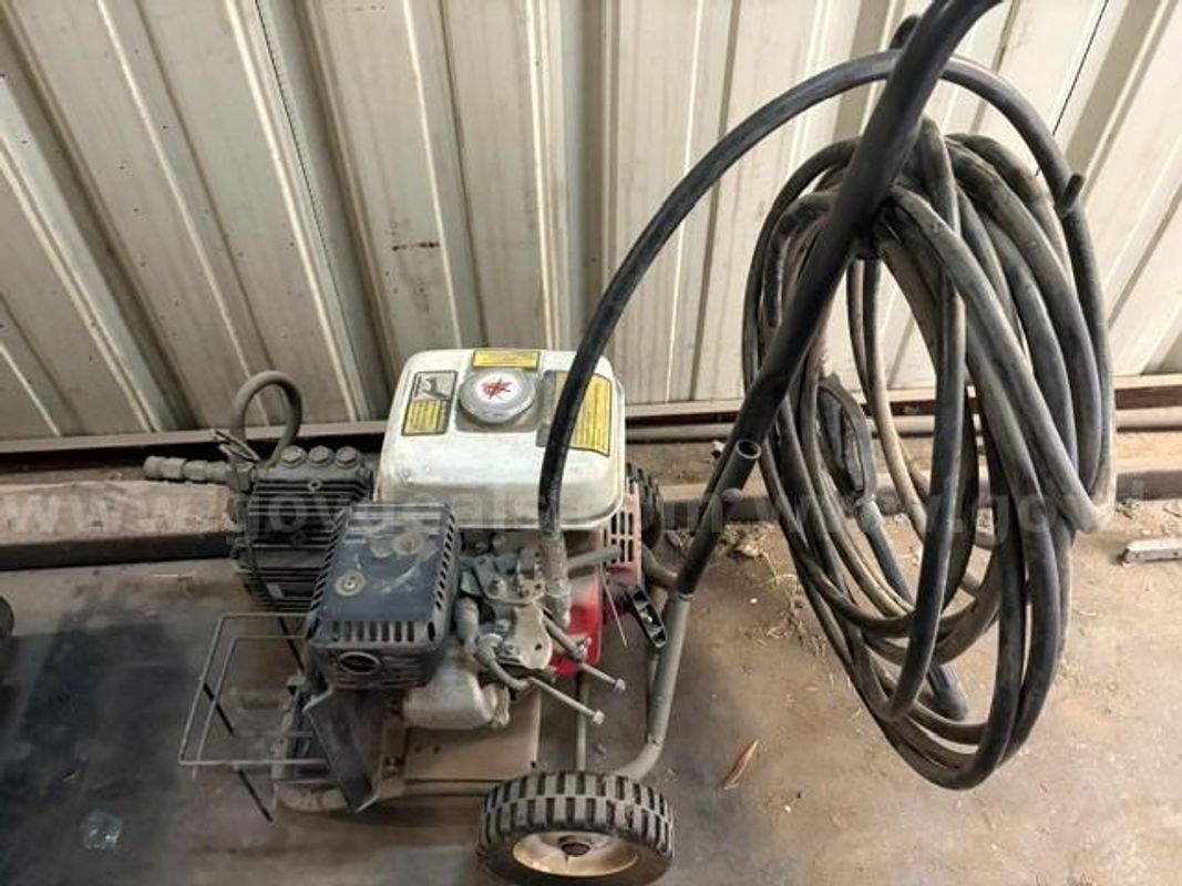 Pressure washer commercial-grade equipped with a Honda GX-series engine mounted on a wheeled utility frame