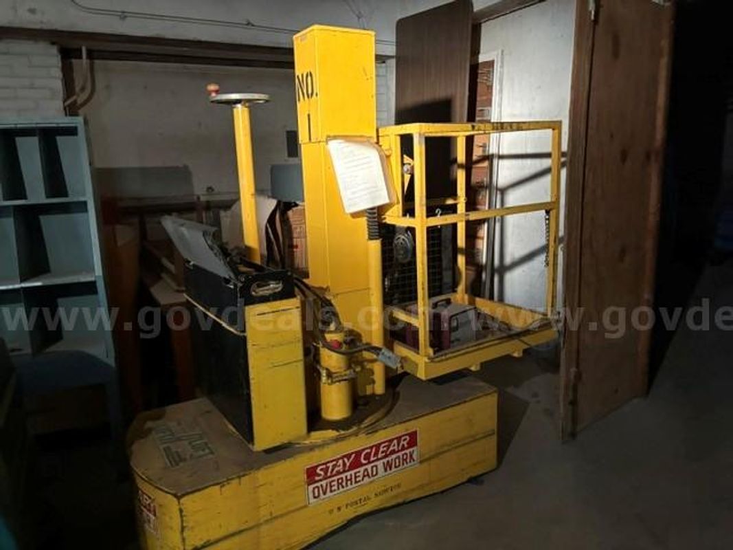 Vert-A-Lift yellow industrial stock picker or maintenance platform truck