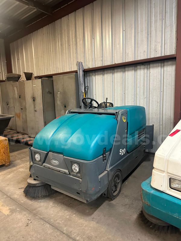 Tennant S20 Compact Ride-On Sweeper, a mid-sized industrial floor sweeper designed for indoor and outdoor cleaning