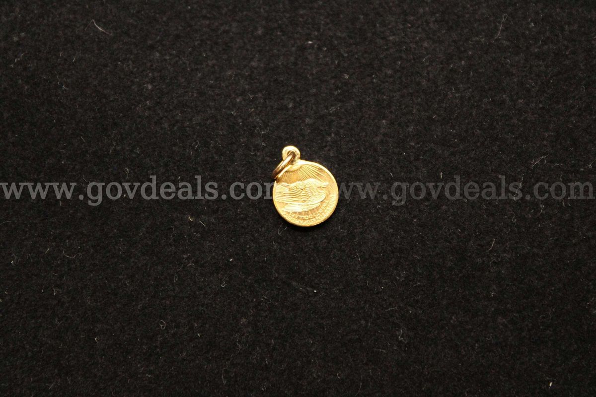 1- Small Gold Colored Coin In A Gold Colored Bezel