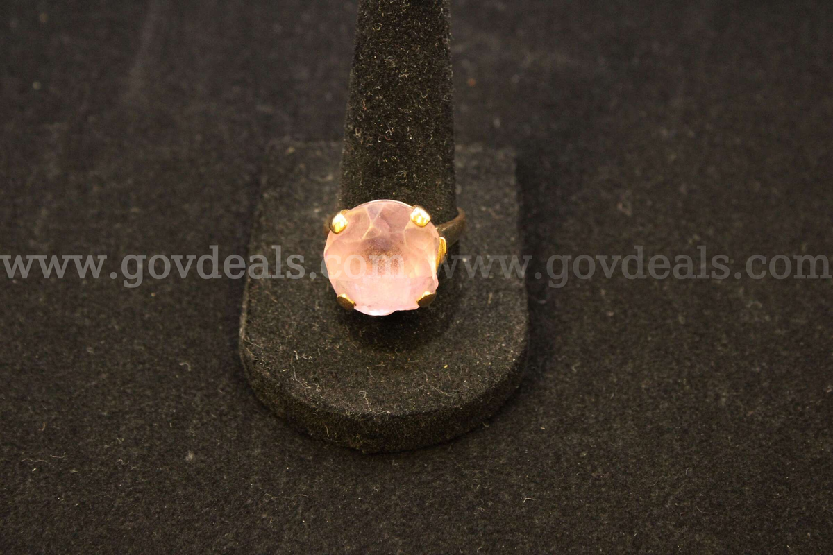 1- gold colored ring with a colored stone