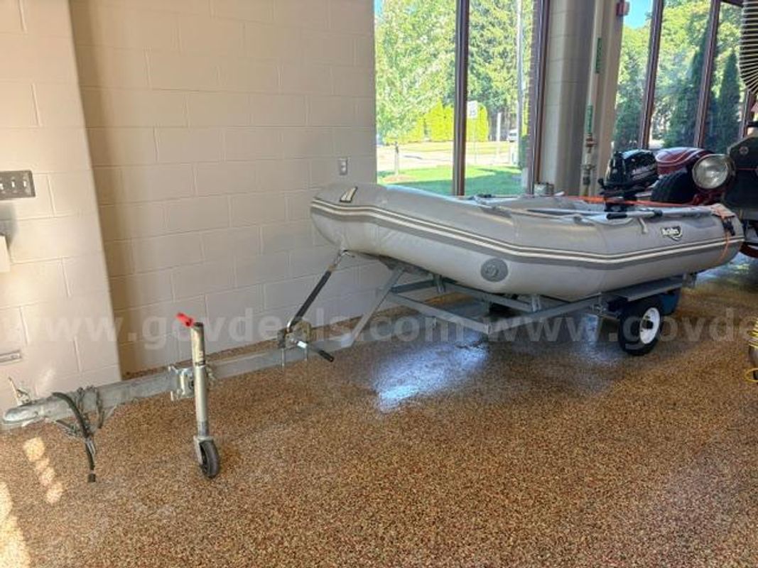 10 foot inflatable boat with 6hp outboard motor and trailer