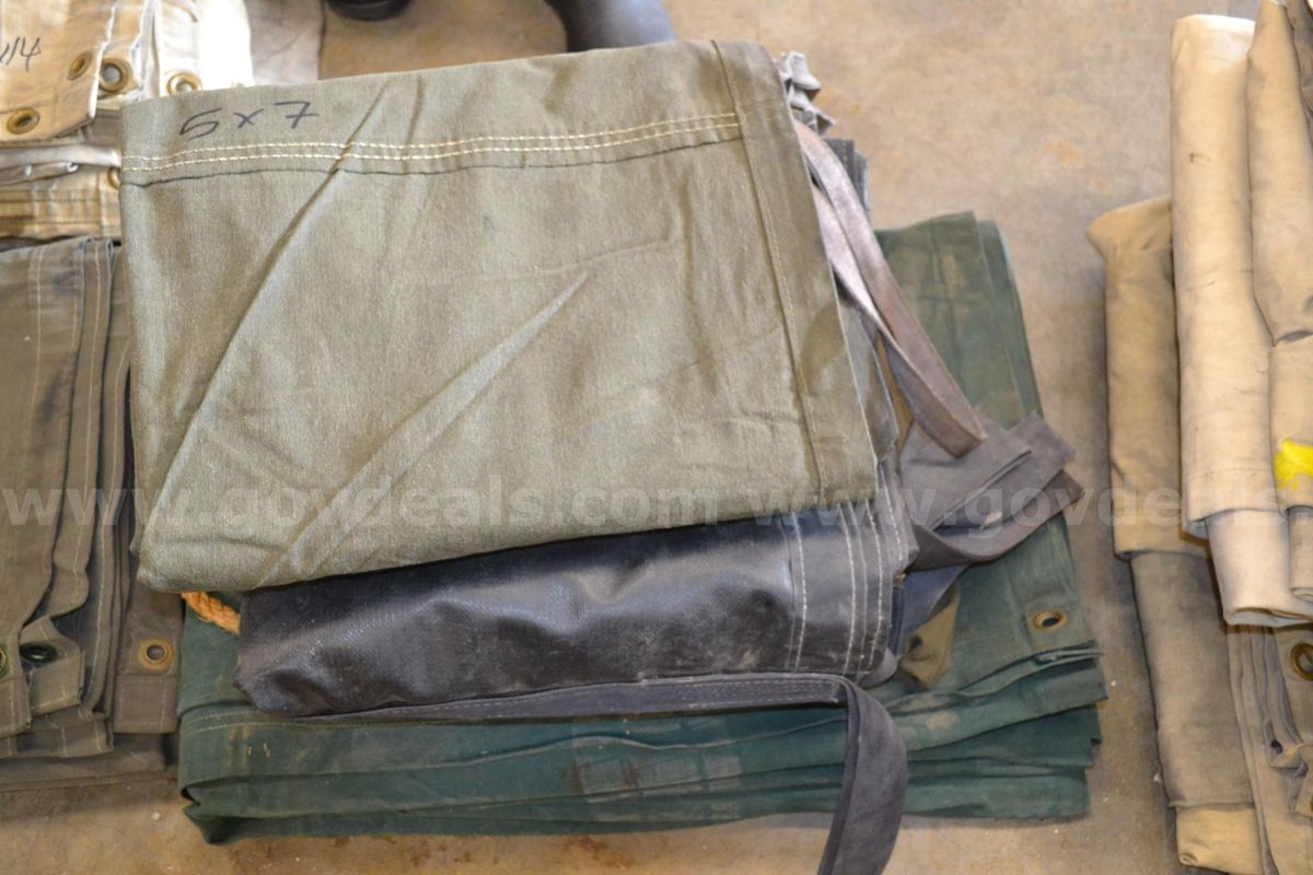 Lot to include Two (2) 11' x 16' canvas tarps, Two (2) 5' x 5' canvas carryall tarps, and One (1) 5' x 7' canvas tarp