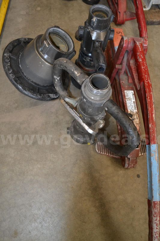 Lot to include Lever style hose clamp, 1.5" Fog nozzle, 2.5" Deck gun fog nozzle, and a 2.5" nozzle valve