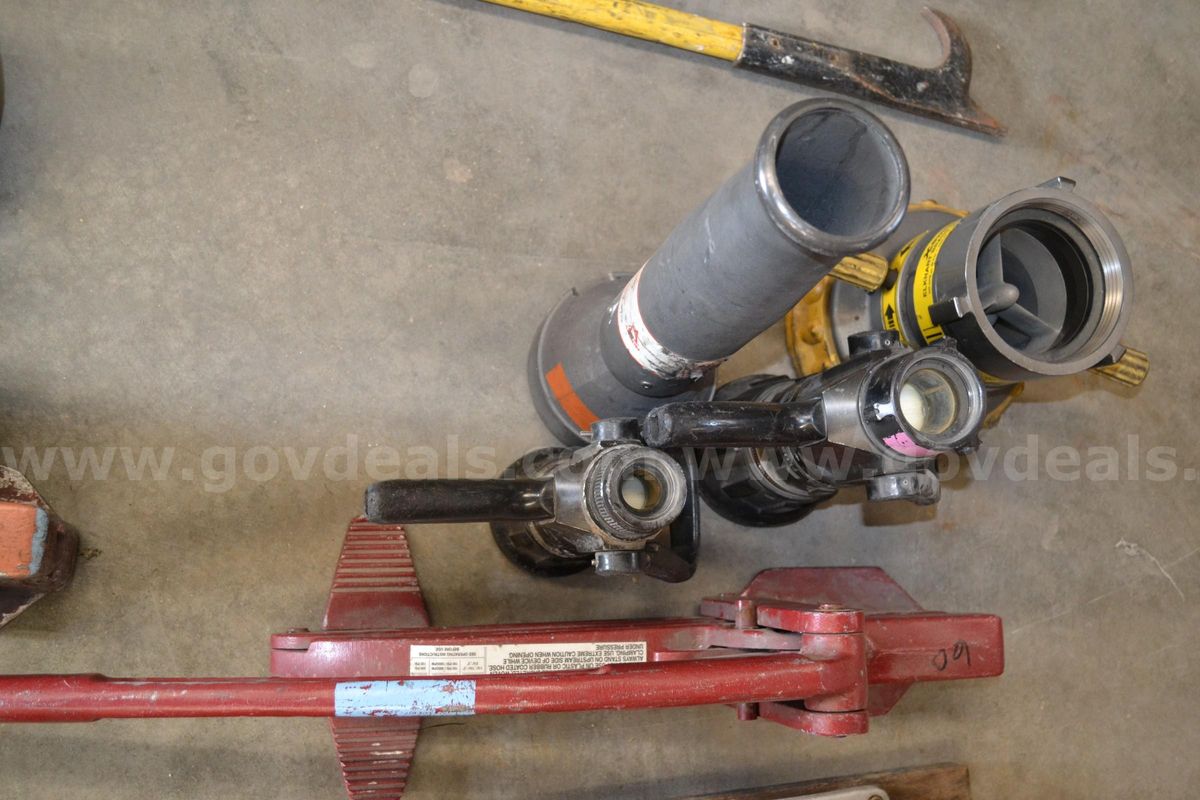 Lot to include lever style hose clamp, 5" Screw type hose clamp, 1" Fog Nozzle, 1.5" Fog Nozzle, 2.5" Deck gun fog nozzl