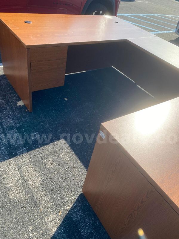 L-shaped wood desk with drawers and wood bookshelf