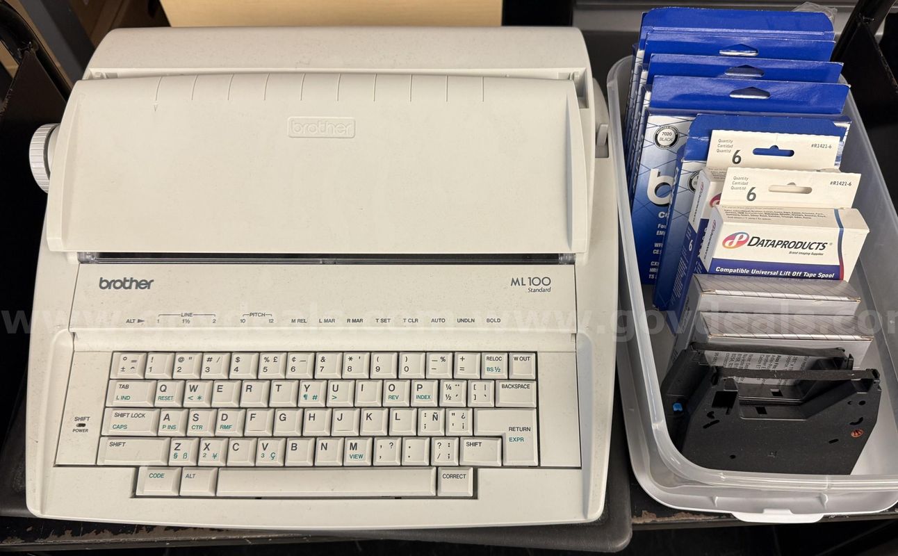 Brother ML 100 Standard typewriter with lid, various ribbons and corrective film ribbons, and cushioned pad (works!)