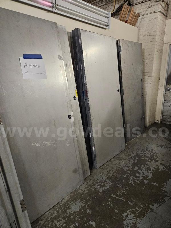 20 Metal Doors and 8 Stack of Metal Door Bucks. Sold As Is.
