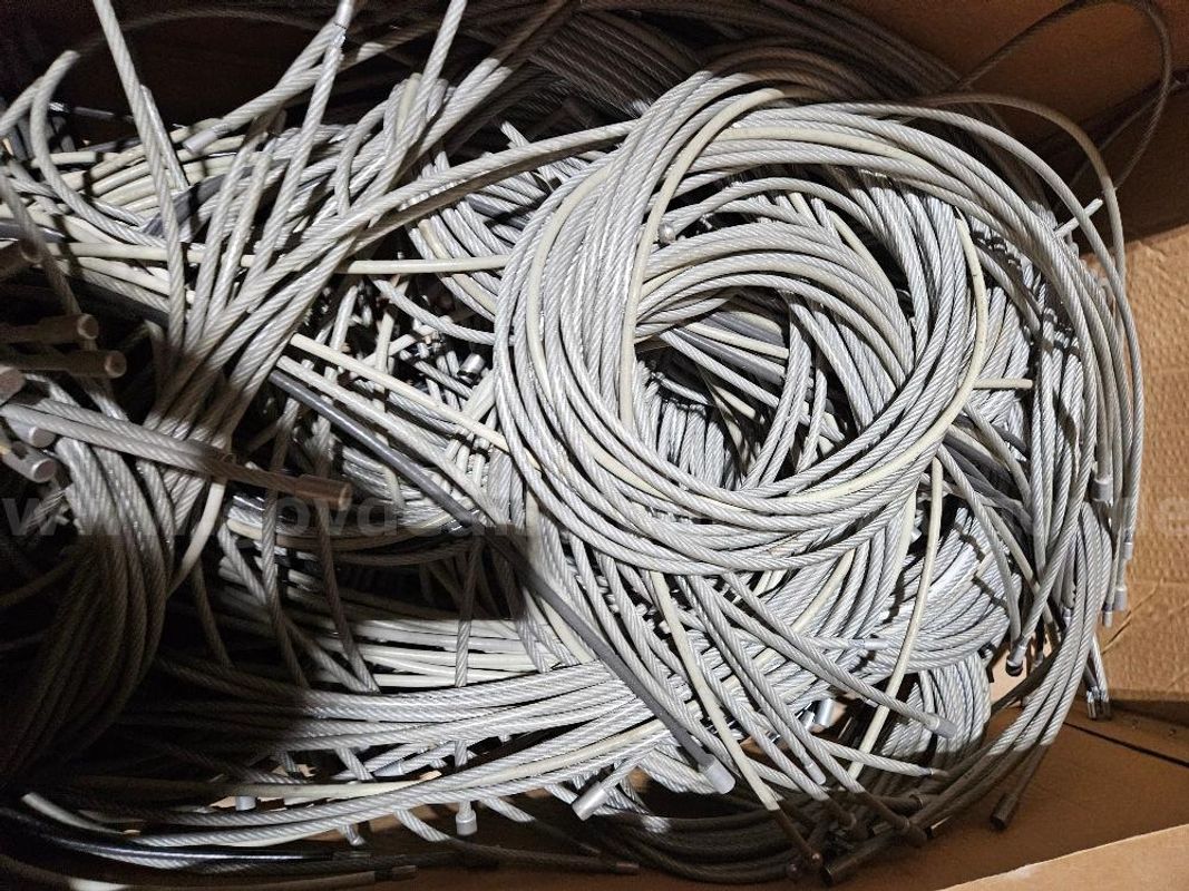 Approx. 200 Silver Security Cables and 30 White Cables. Sold As Is.