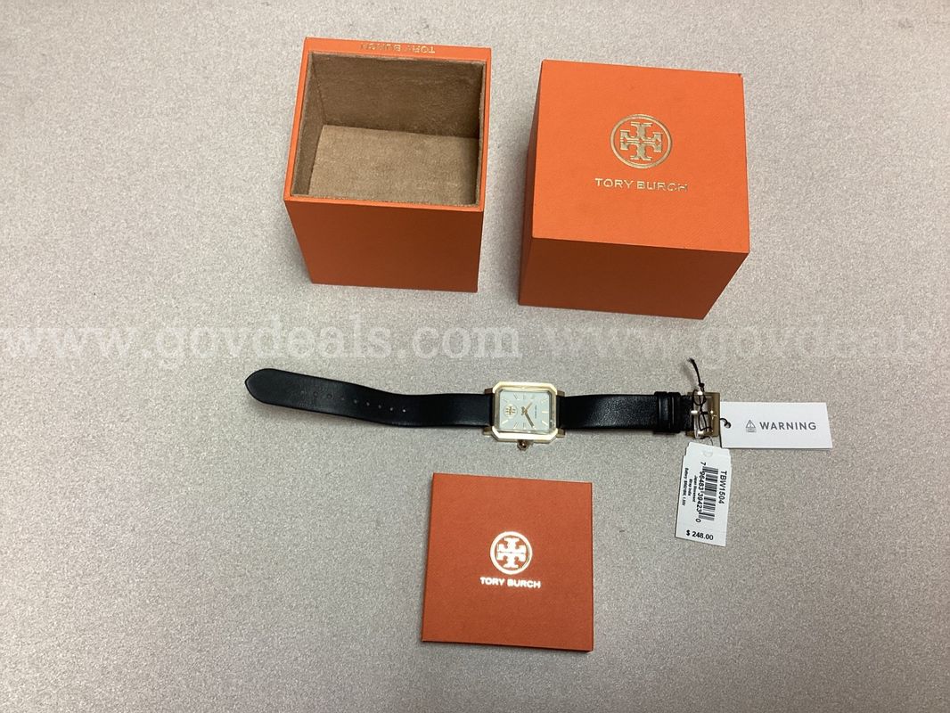 Tory Burch watch featuring a gold tone rectangular case and black leather strap