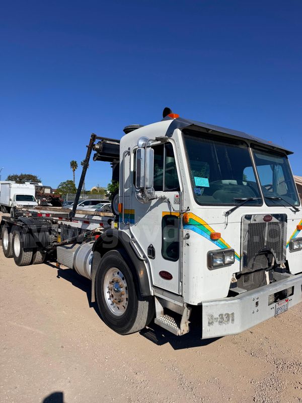2009 Peterbilt 320 6x4 COE Roll-Off Truck