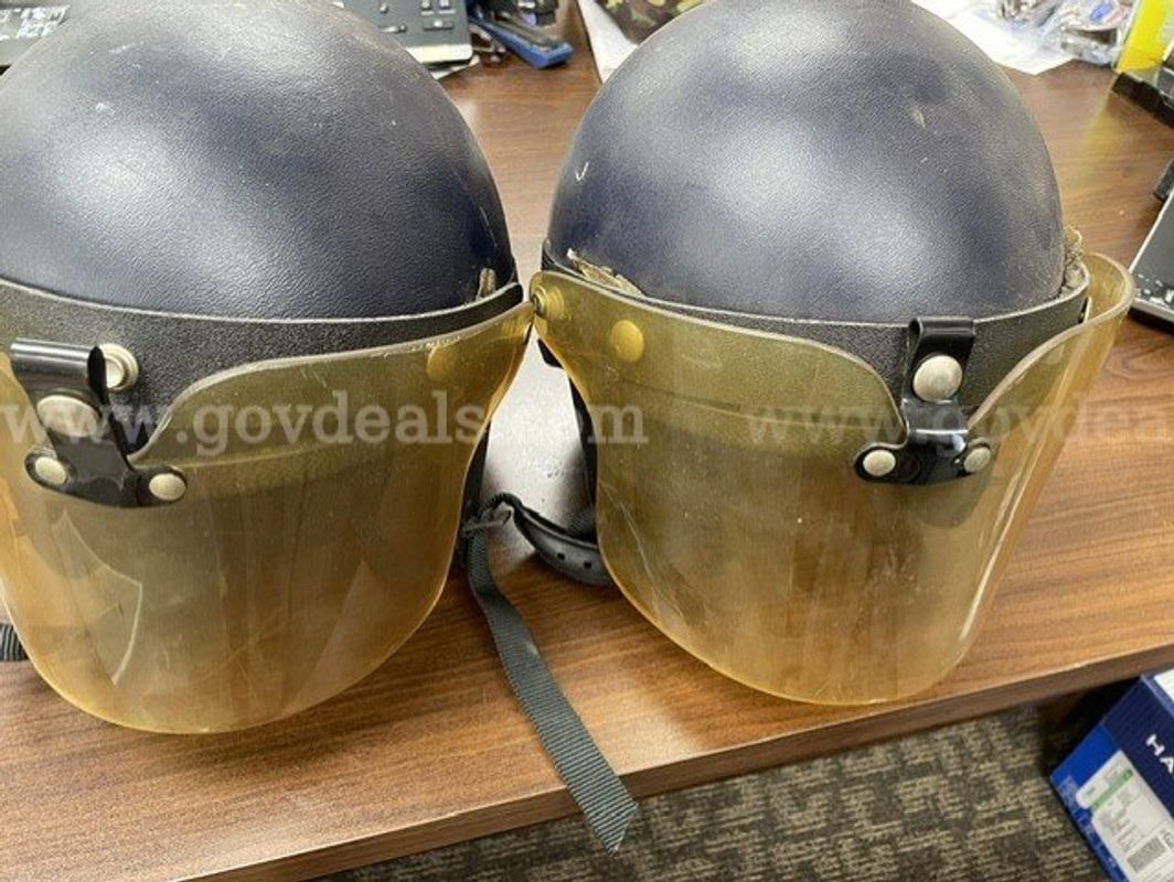 Lot of 2 used dark protective helmets with tinted face shields