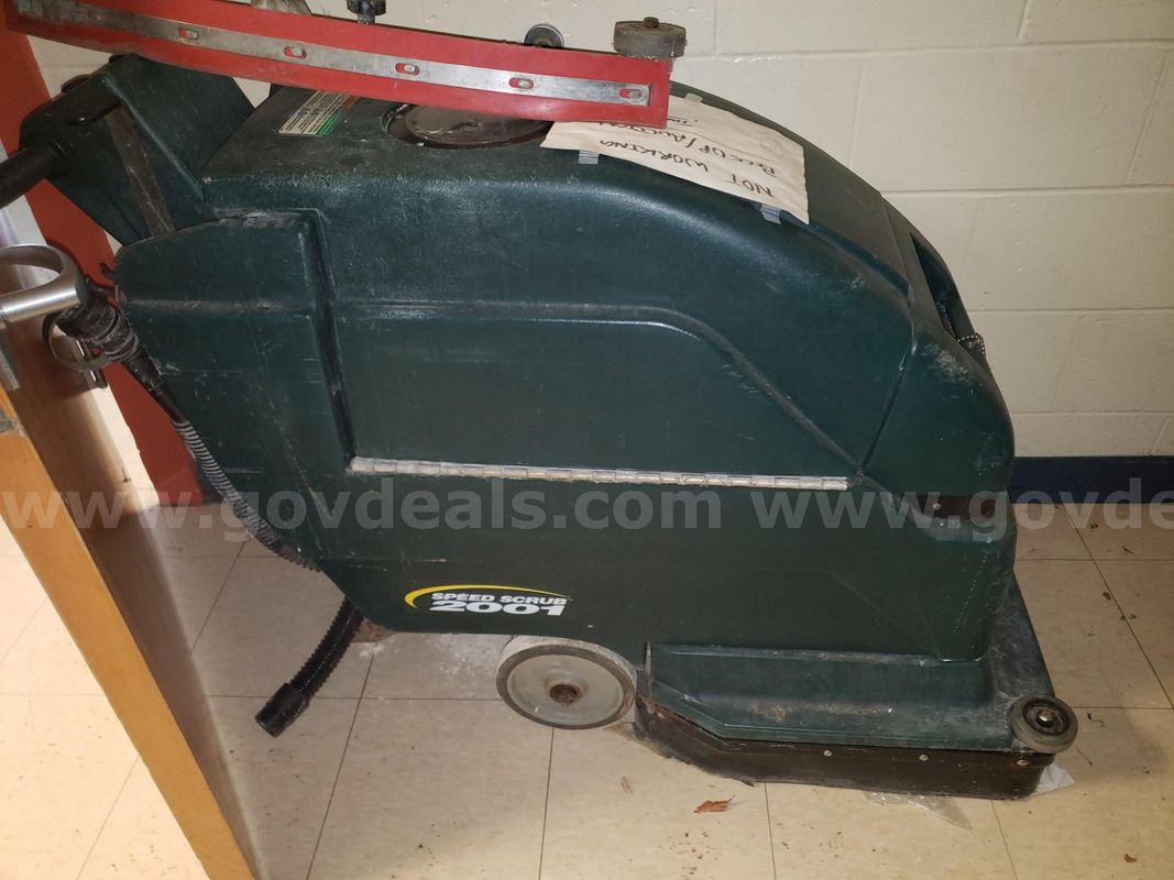 Walk- Behind floor scrubber.