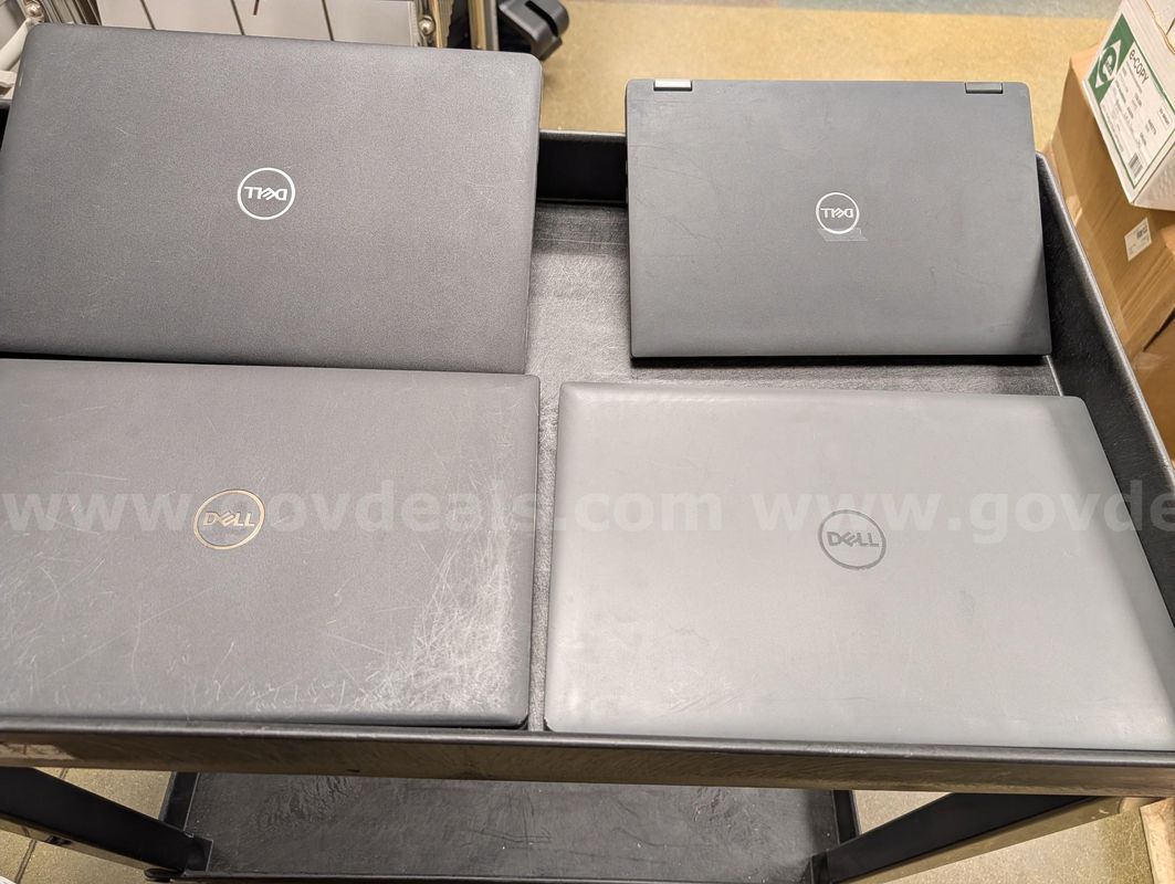 Surplus lot containing four (4) Dell Latitude and one (1) box of assorted miscellaneous office supplies